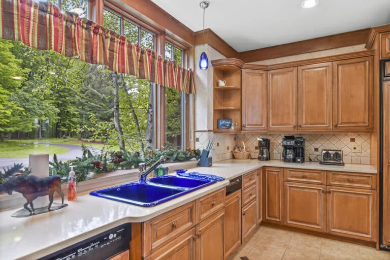 A kitchen with wooden cabinets and a window.